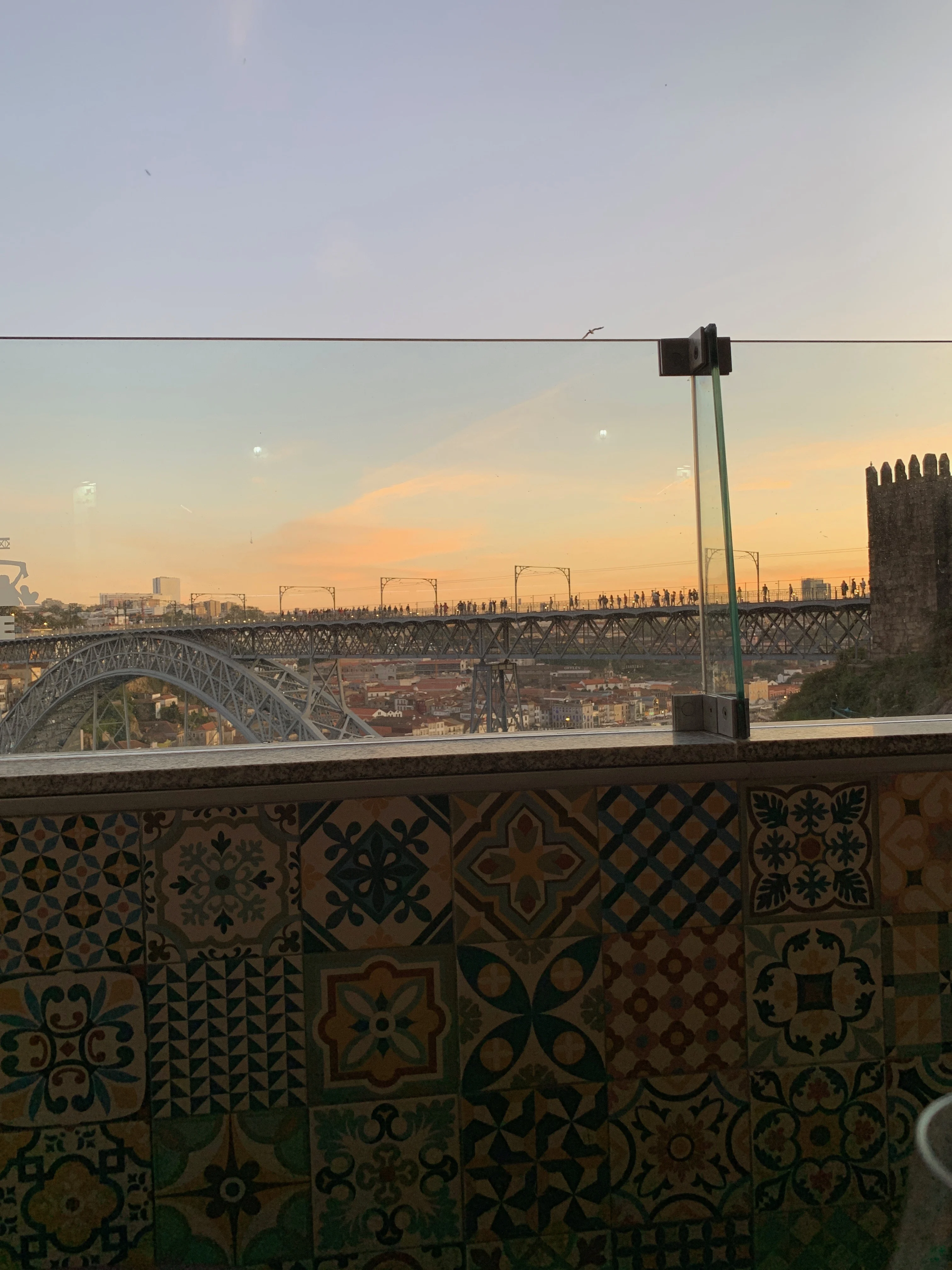 The beautiful, colored tiles that decorate the walls of Guindalense Futebol Club with the bridge in the background