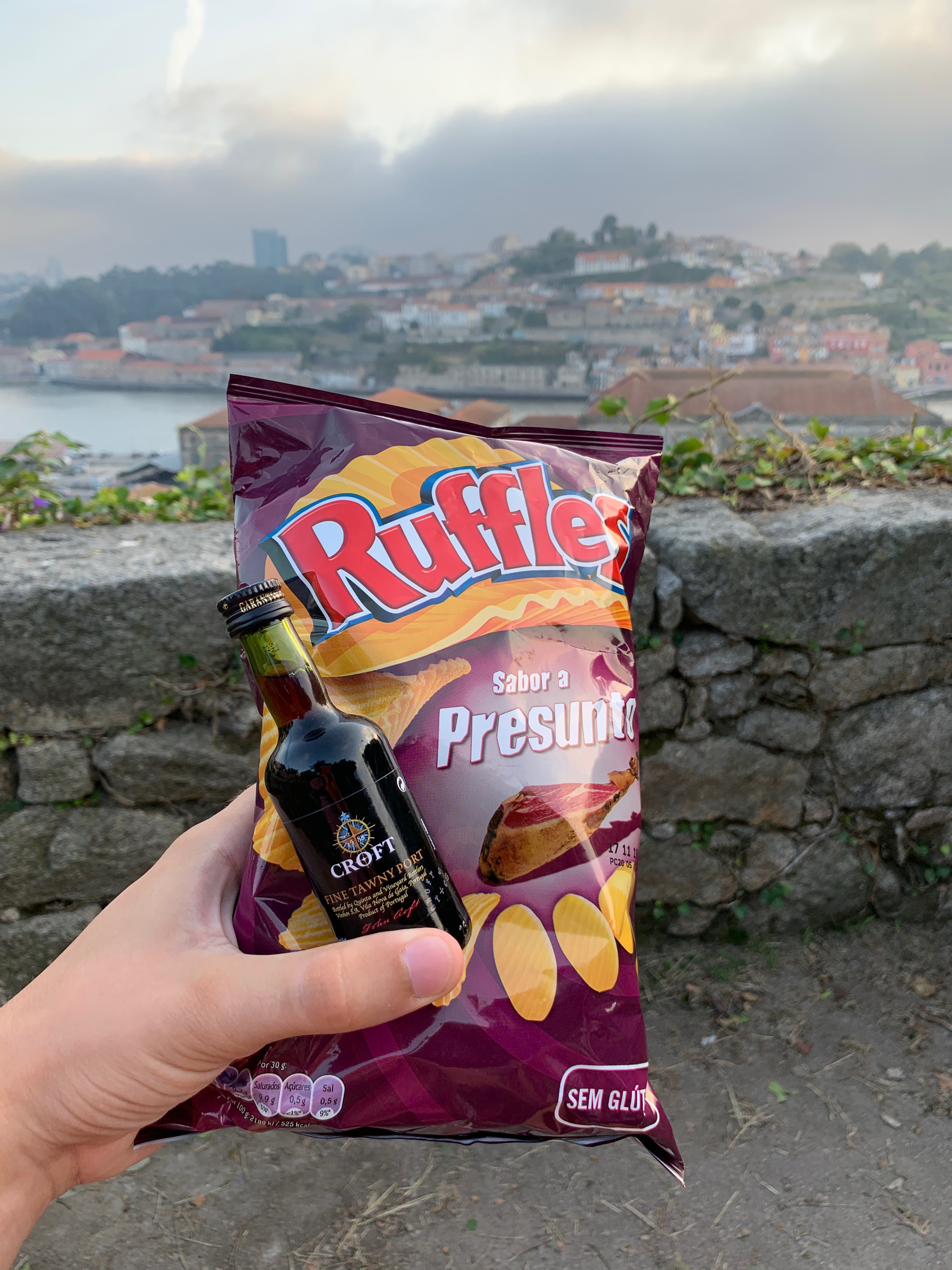 A mini bottle of port and chips with the Douro river in the background