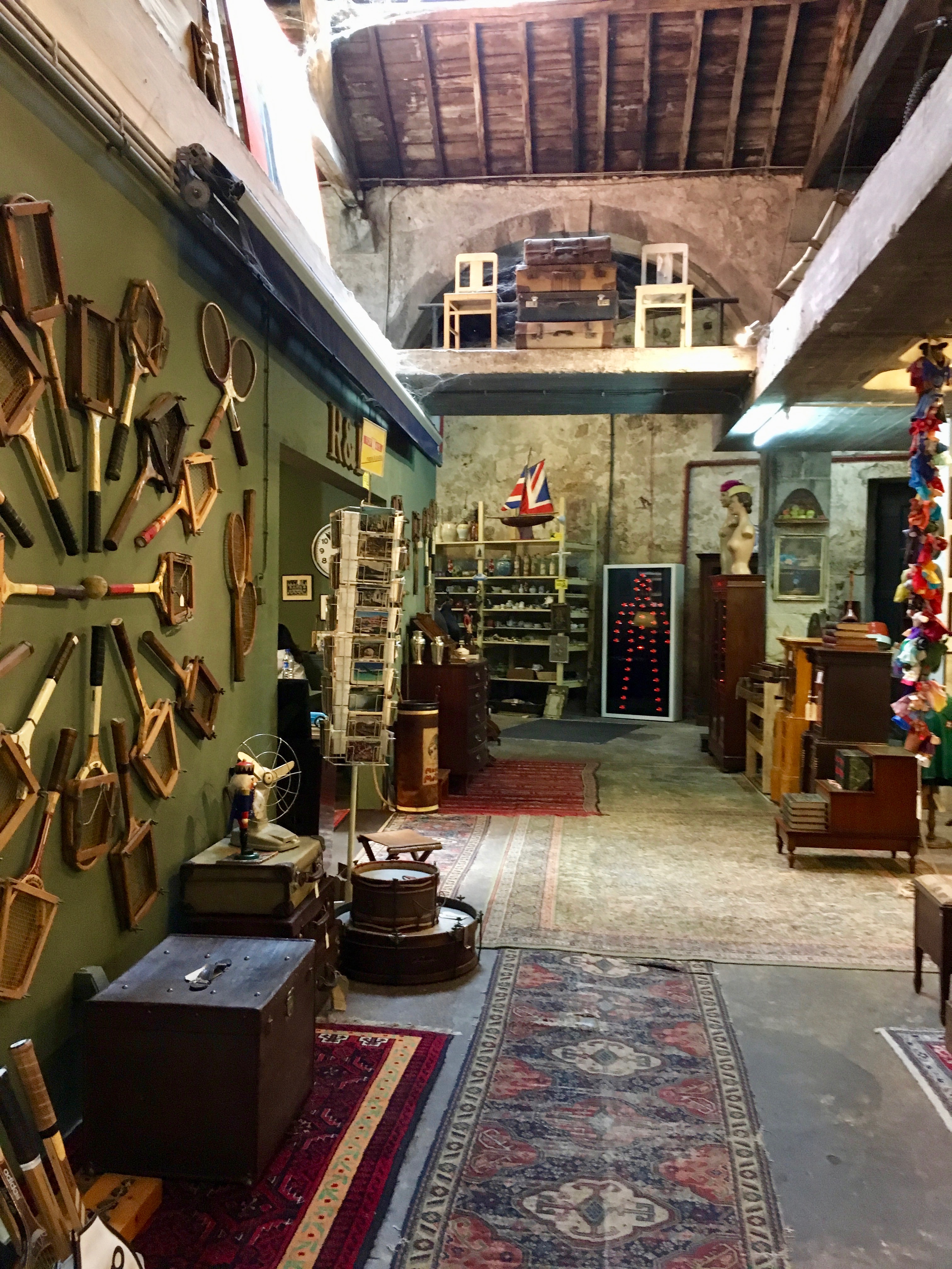 The interior of Armazém, with eclectic furniture in a warehouse-like setting