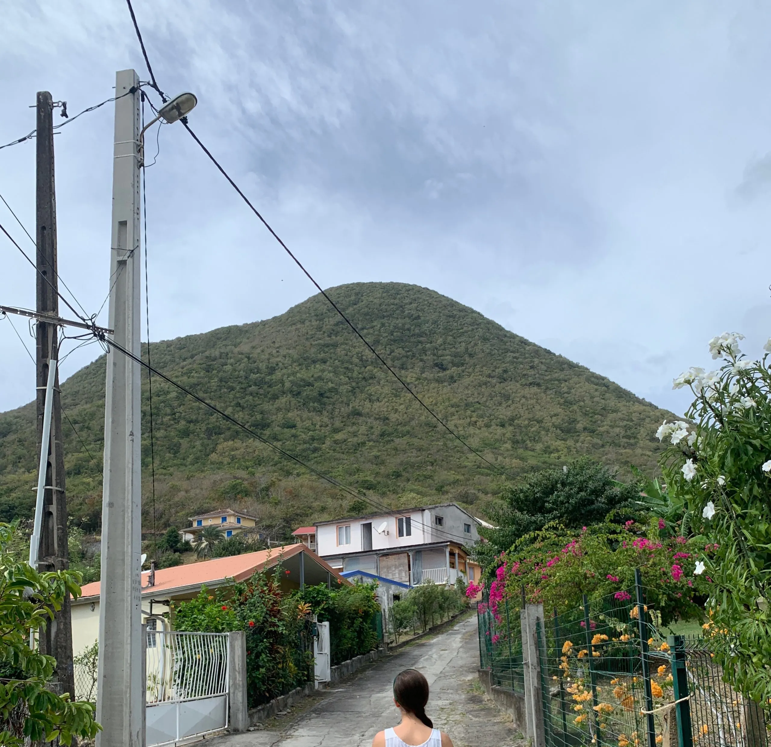 A road leading to the trail head of Morne Larcher with the mountain in the background