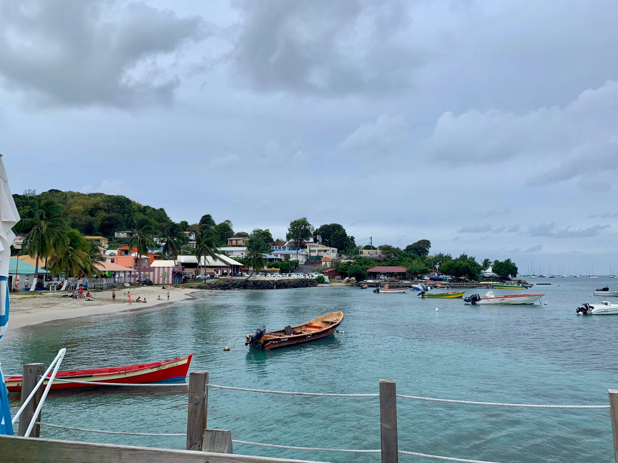 Colorful boats on turquoise water in Sainte-Anne