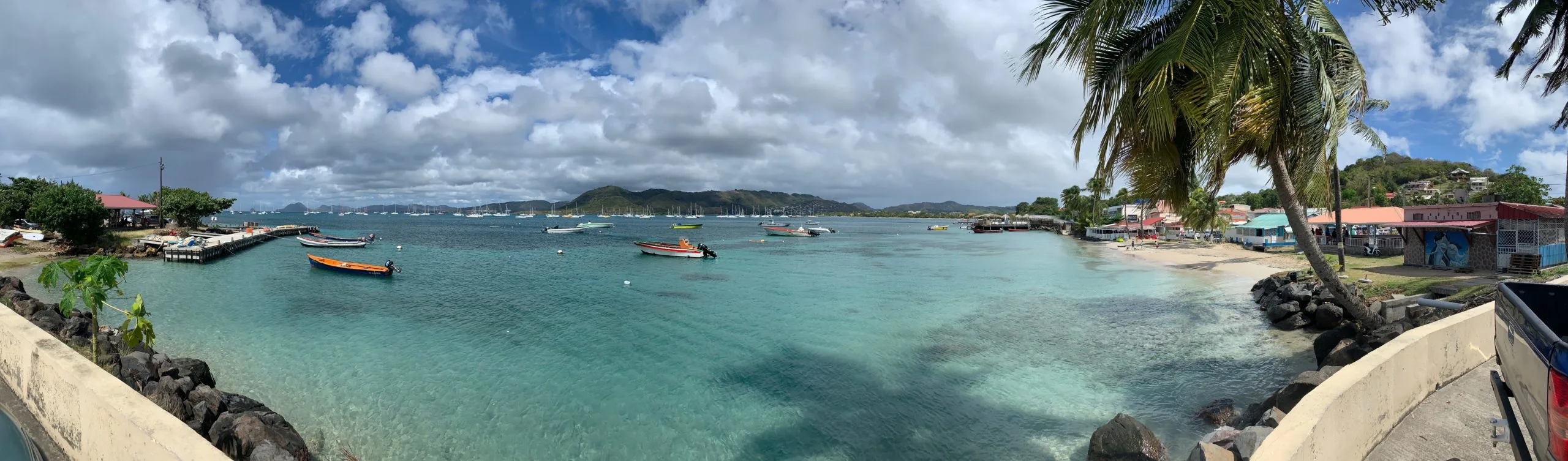 Blue water, boats, and palm trees in beautiful Sainte-Anne