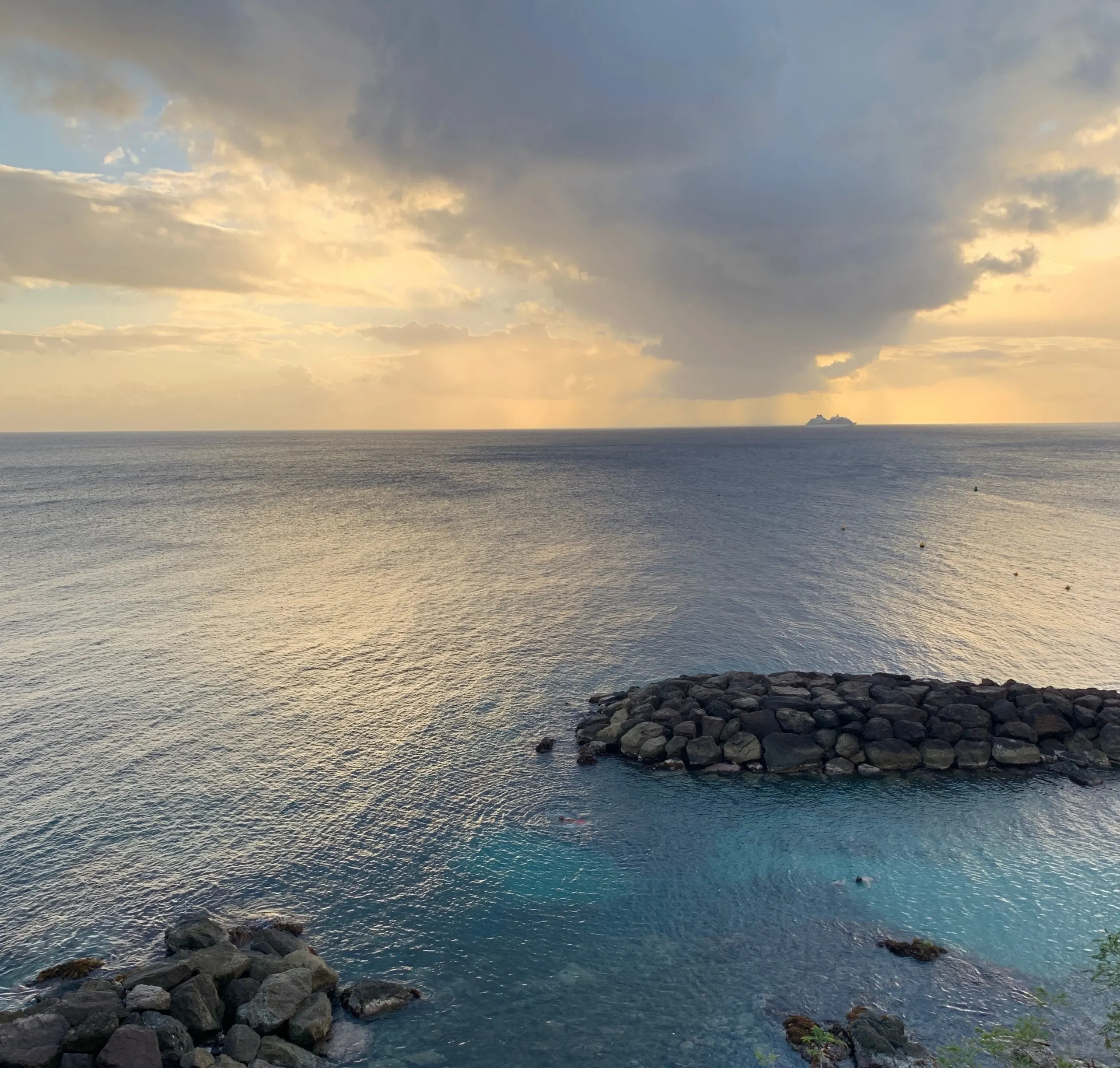 View of a cruise ship leaving Martinique in the far distance and the sunset from above Lili's Beach bar