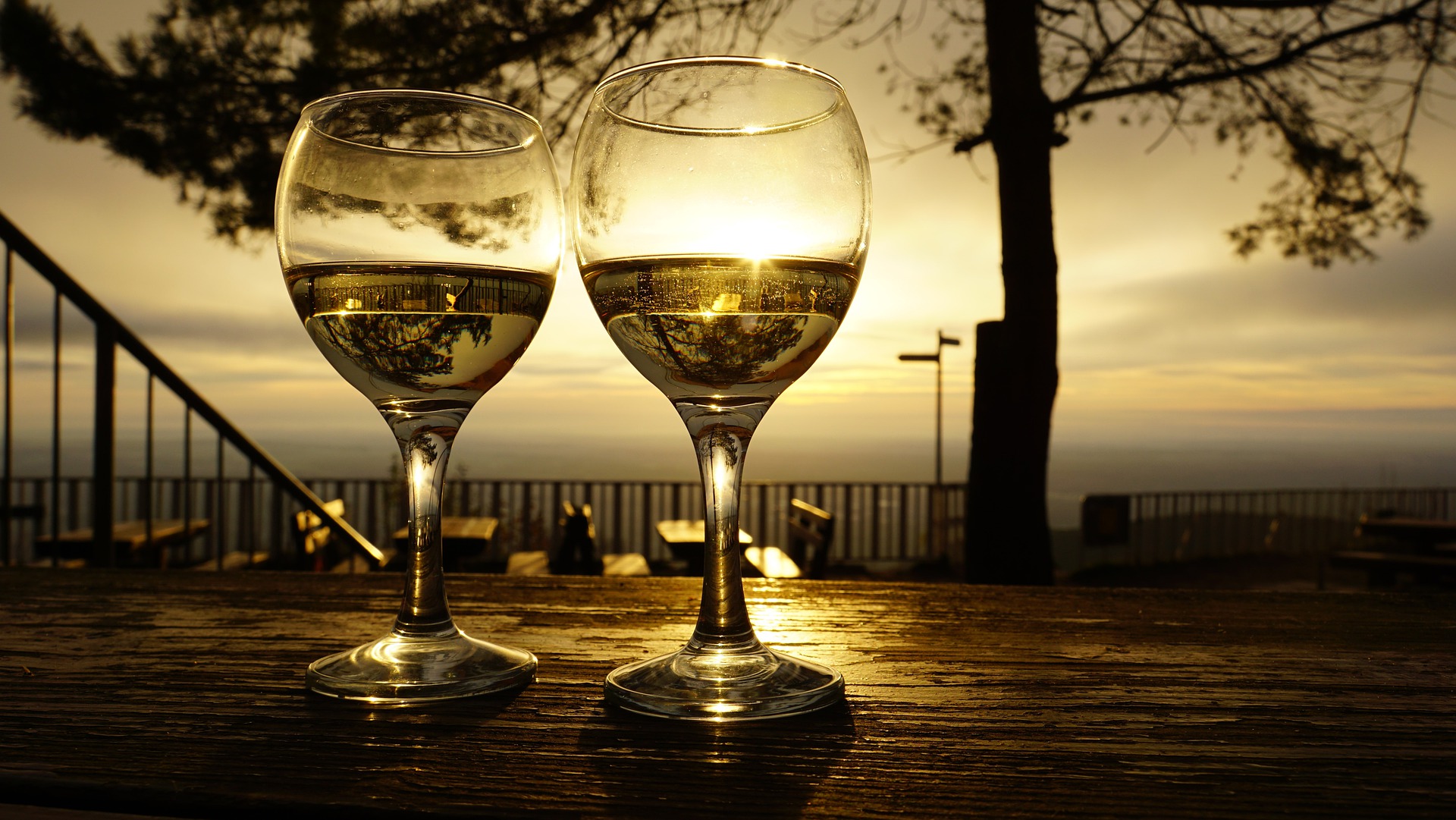 Two glass of wine on a table on a chilly fall morning.