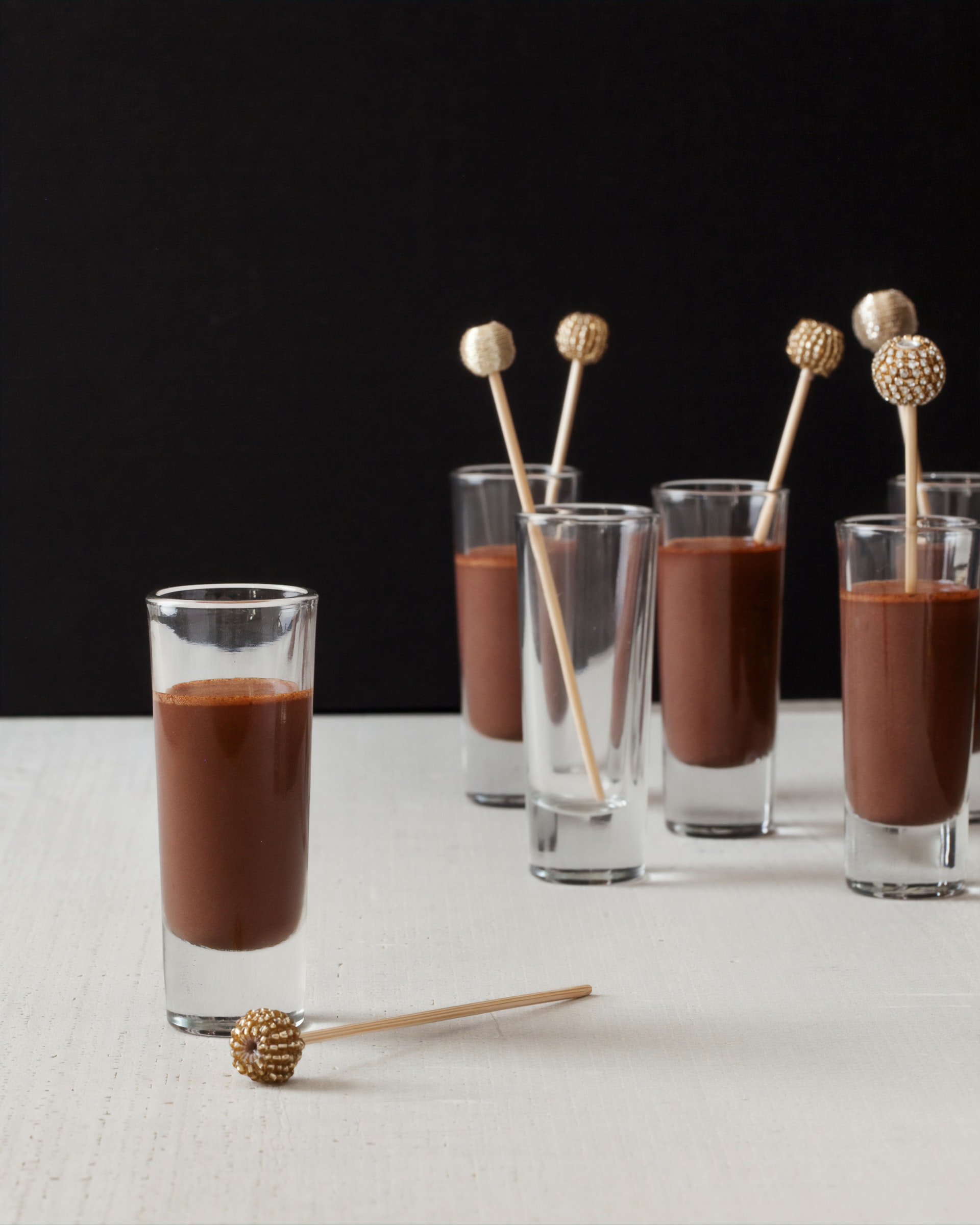 Chocolate RumChata pudding shots on a table.