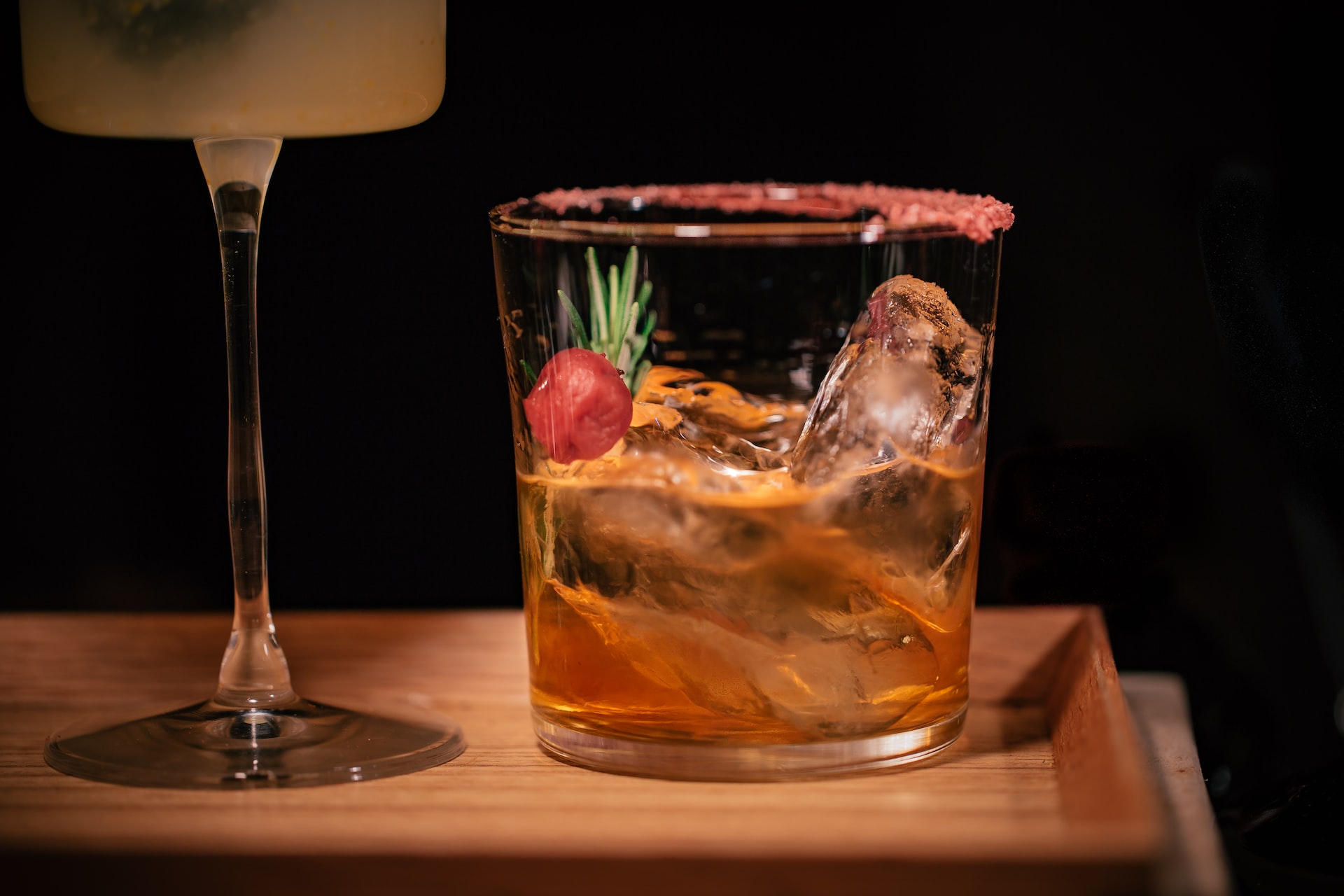 Two Cynar cocktails on a wooden tray. 