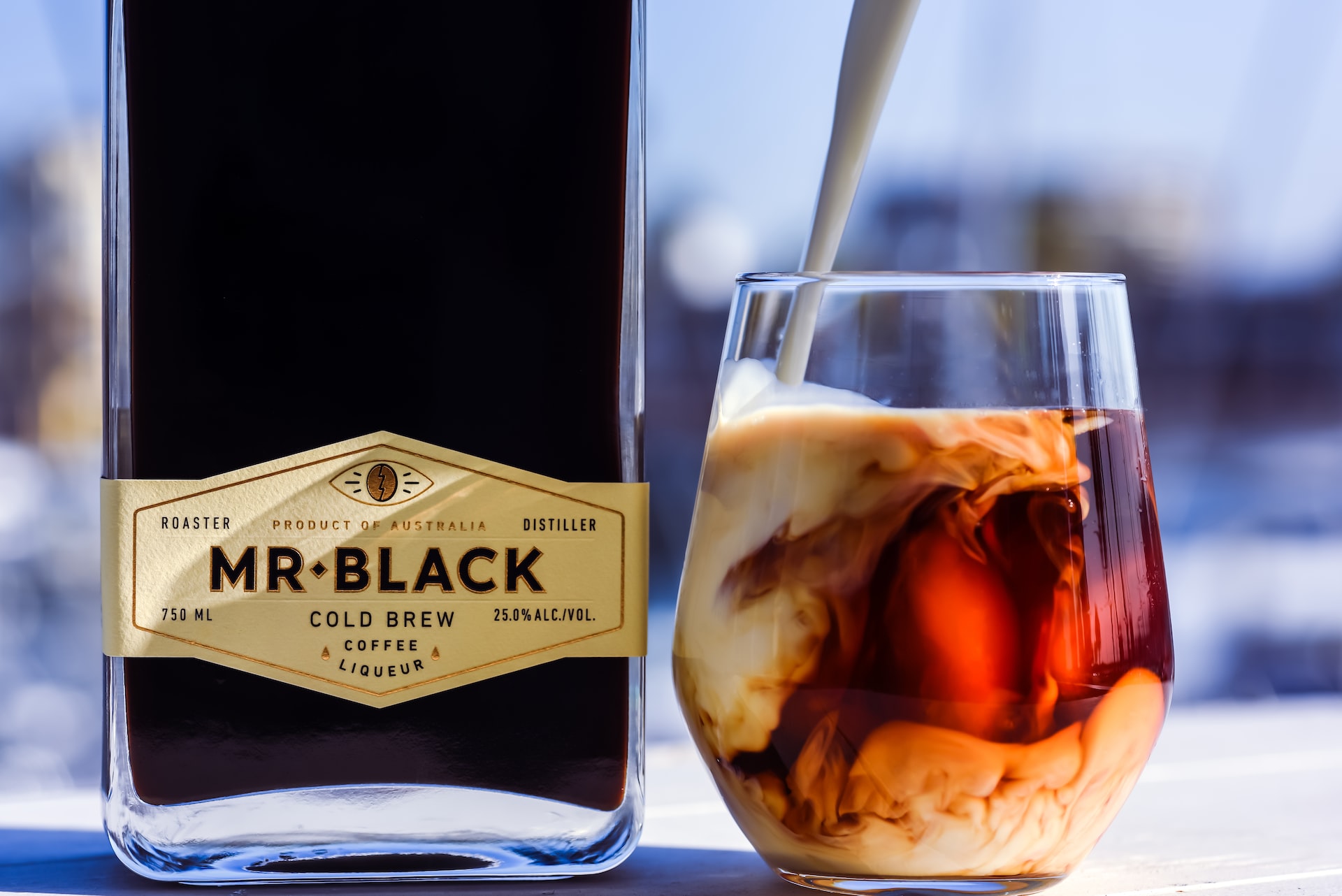 A bottle of Mr Black next to a White Russian cocktail.