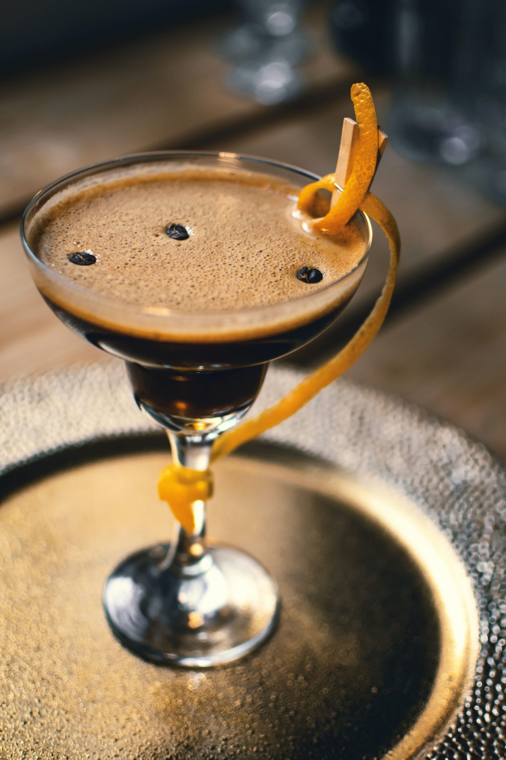 A whiskey-based coffee cocktail with Bénédictine garnished with a thinly sliced orange peel.