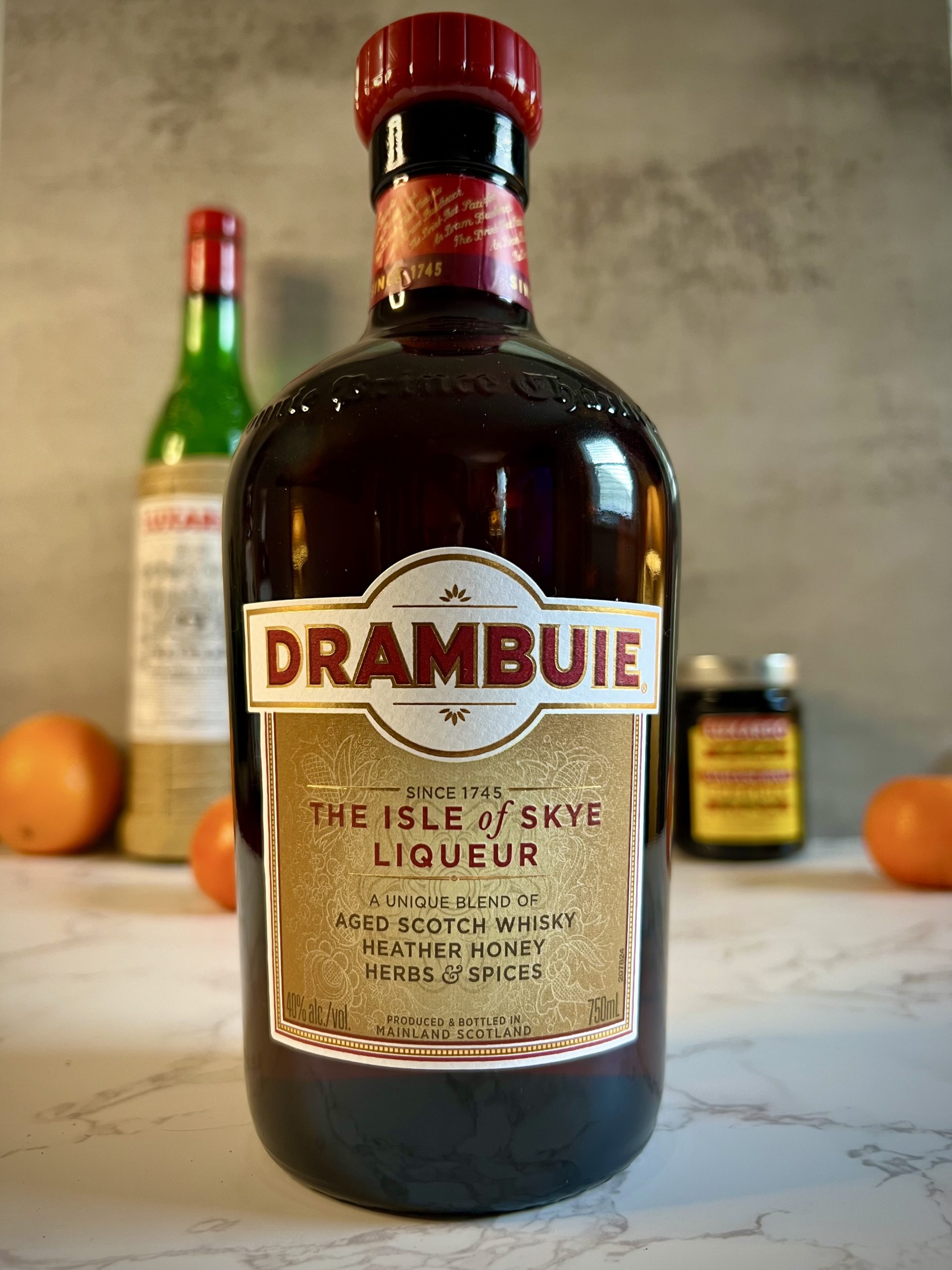 A bottle of Drambuie sits on a countertop.