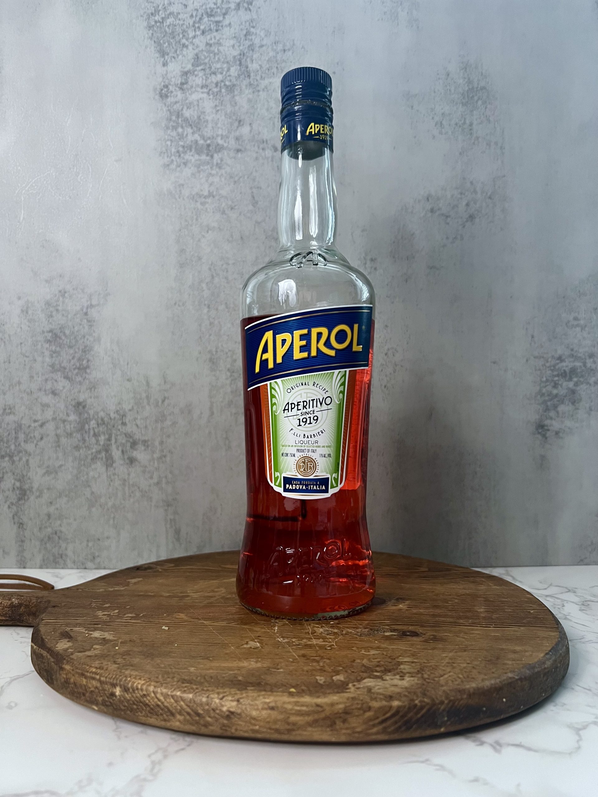 A bottle of Aperol on a countertop.