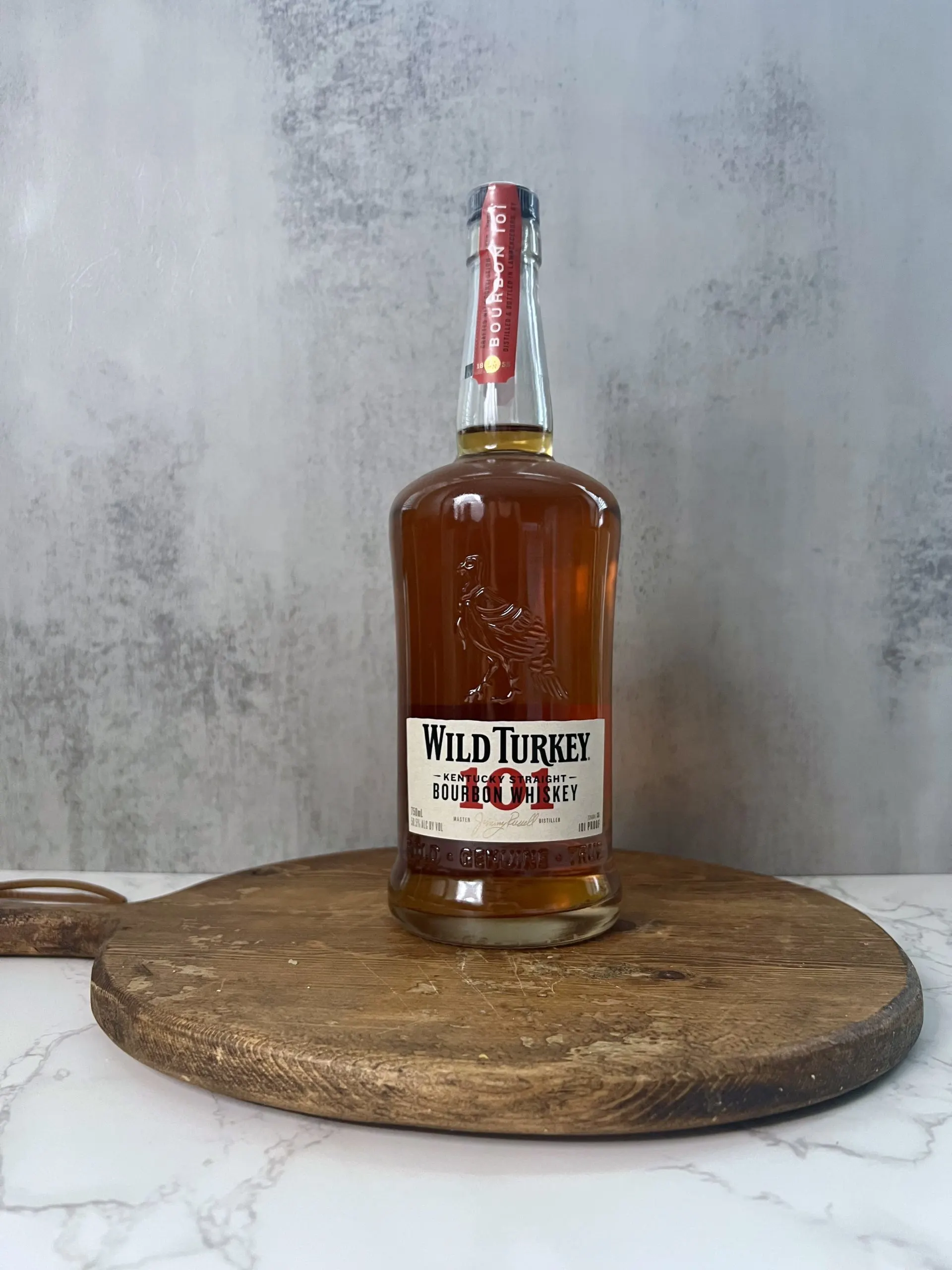 A bottle of Wild Turkey 101 bourbon on a countertop. 